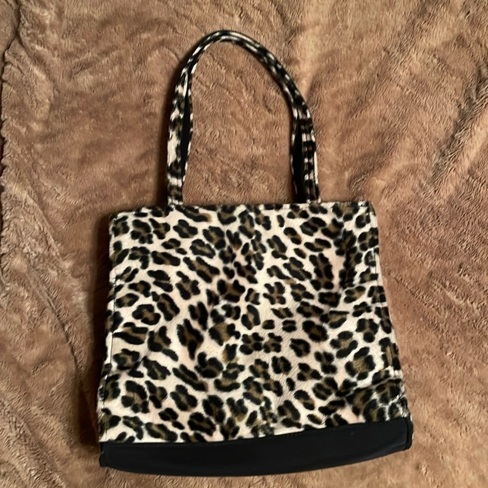 Soft faux fur leopard purse. Snap top; inside zipper pocket.
